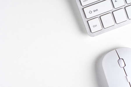 White computer mouse and keyboard on white backgroundの写真素材