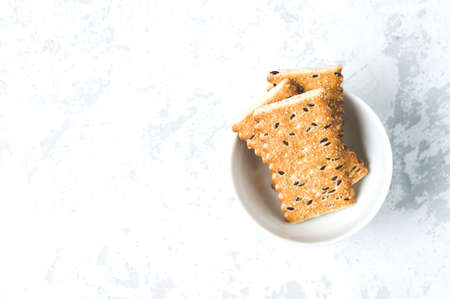 Cookies in a white Cup on a white backgroundの写真素材