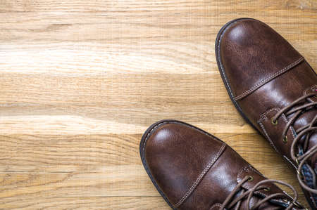 Leather men's shoes on wooden backgroundの写真素材