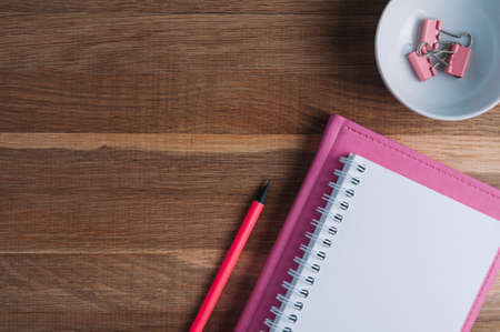 Pink notebooks and stationery on the table
