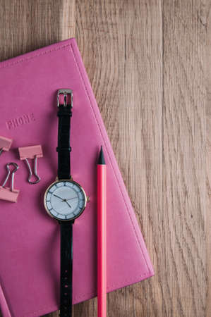 Pink notebooks and stationery on the table