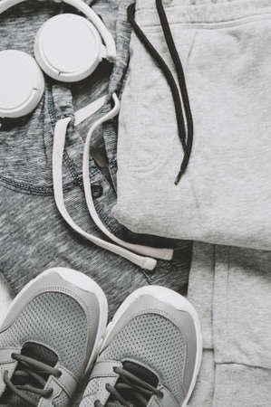 Sportswear and sneakers on the grey background. The concept of sport or exercise