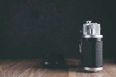 Old camera and lens on dark background
