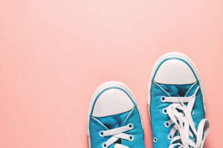 Blue shoes on a pink background