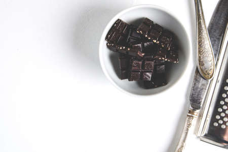 Pieces of dark chocolate on a light backgroundの写真素材