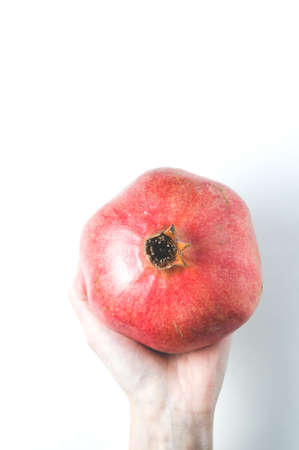 Red pomegranate in a woman handsの写真素材