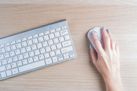 Keyboard top view and a woman's hand
