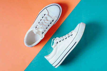 White sneakers on a green-pink background