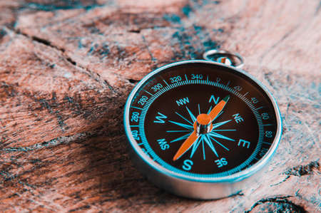 Old compass on a dark wooden background. Copy space for text or designの写真素材