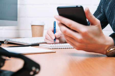 Business woman writes in a notebook. The concept of office work