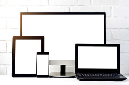 Monitors and tablets on a light background. Template for text or design of the websiteの写真素材
