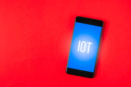 Black smartphone on red  background. Template for appsの写真素材