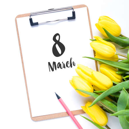 Yellow tulips on white background. The concept of spring or women's dayの写真素材