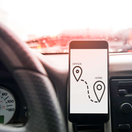 Mobile phone on the dashboard of the car. Template for text or designの写真素材