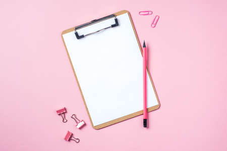 Clipboard and pencil on pink background. Template for text or designの写真素材