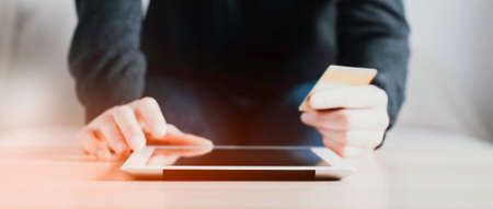 A woman holding a notepad and credit card in her hands. The concept of online shopping or money...