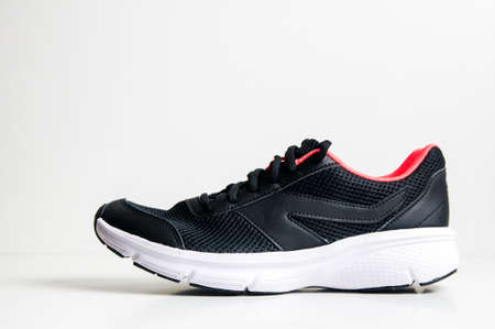 Black sneakers on a white backgroundの写真素材