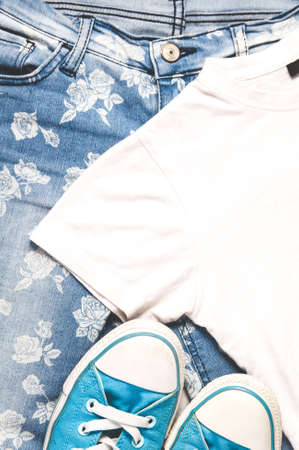 Blue women's jeans with floral pattern and t-shirtの写真素材
