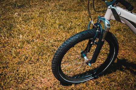 Bike on grass, view from the front wheelの写真素材