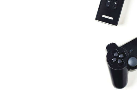 Game joystick and TV remote on a white background