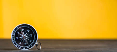 Old compass on an yellow background. Copy space for text or designの写真素材