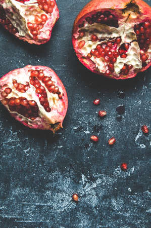 Ripe pomegranates on a dark backgroundの写真素材