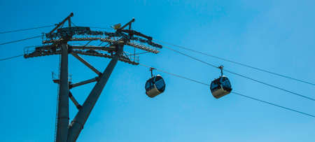 Cable car with cabins on background of blue skyの写真素材