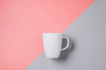 White mug on pale pink background. Template for text or designの写真素材