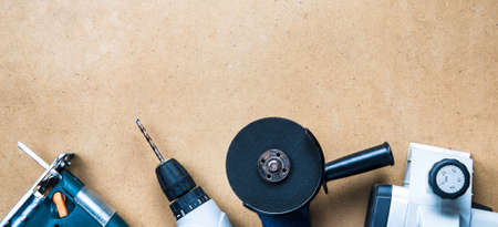 Modern electric tools on the background of hardboardの写真素材