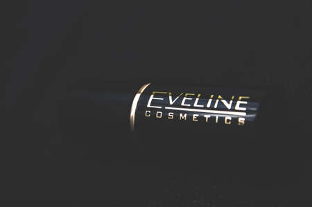 Russia, Moscow, October 02, 2019: Eveline Cosmetics logo and text lipstick on a dark background