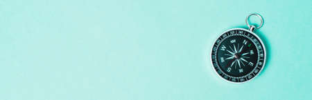 Old compass on a green background. Copy space for text or design