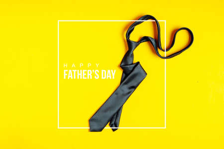 Men's black tie on a yellow backgroundの写真素材