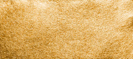 Gold foil texture close-up. Background for text or designの写真素材