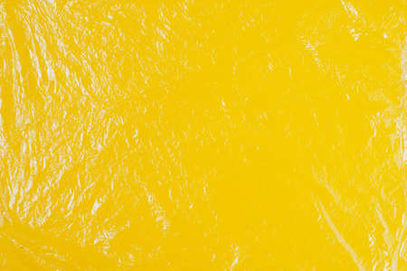 Transparent cellophane texture on an yellow backingの写真素材