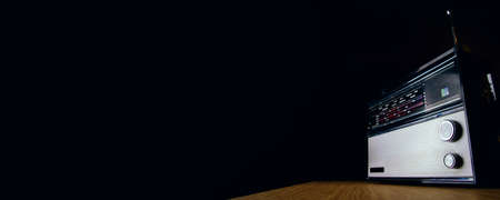 An old analog radio on a dark background. Space for text or designの写真素材