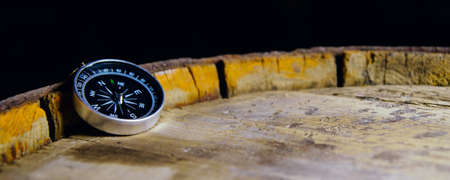 Compass on an old wooden barrel