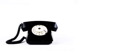 Vintage black dial phone isolated on white backgroundの写真素材