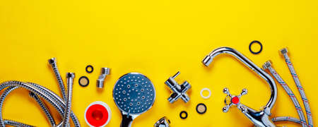 Set of plumbing for bathroom or shower on an yellow background. Flat lay and top view, copy space...