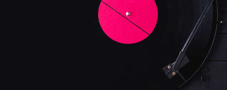 Vinyl record with red label and old playerの写真素材