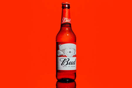 Russia, Moscow, June 27, 2020: Bottle of "Bud" beer on a red backgroundのeditorial素材