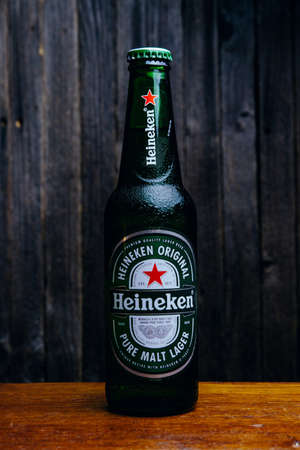 Russia, Moscow, July 11, 2020: Bottle of "Heineken" beer on a wooden table and dark backgroundのeditorial素材