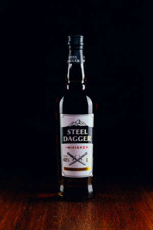 Russia, Moscow, July 13, 2020: Bottle of "Steel Dagger" whiskey on a wooden table and dark backgroundのeditorial素材