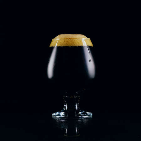 A glass of porter beer on a dark backgroundの写真素材