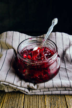Homemade jam from rose petals in a jar on a dark backgroundの写真素材
