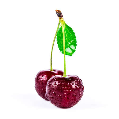 Cherry berry with green leaf in water drops isolated on white backgroundの写真素材