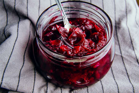 Homemade jam from rose petals in a jar on a dark backgroundの写真素材
