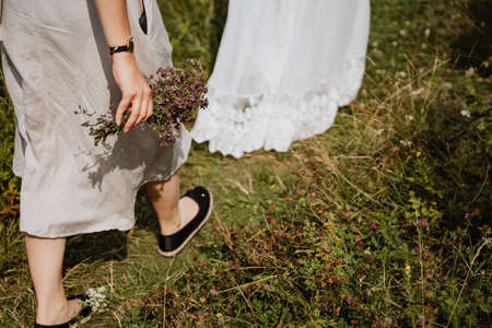 man and woman walking in nature, running in the mountains, holding hands, landscape, outdoors, walking on the road, forestの写真素材