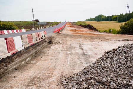 laying of new asphalt, road repairs, highways, road works, gravel, protective fences, marking, going into the distance, old and new, without peopleの写真素材