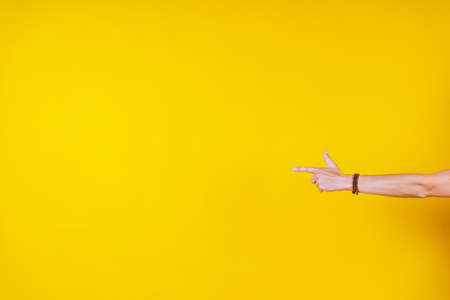 white male hands on a yellow background, fingers bentの写真素材