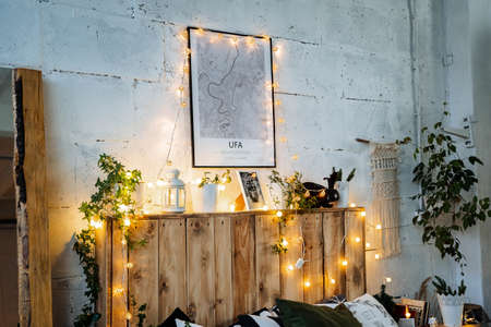 Christmas lights in the interior, Christmas tree with a garland, selective focus, blurred background, evening shooting, holiday atmosphere, picture with noiseの写真素材